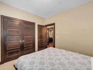 Step into a beautifully designed bedroom featuring rich, dark wood doors that add a touch of elegance.