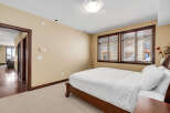 This inviting bedroom features a comfortable bed with crisp white linens, creating a serene and relaxing atmosphere.