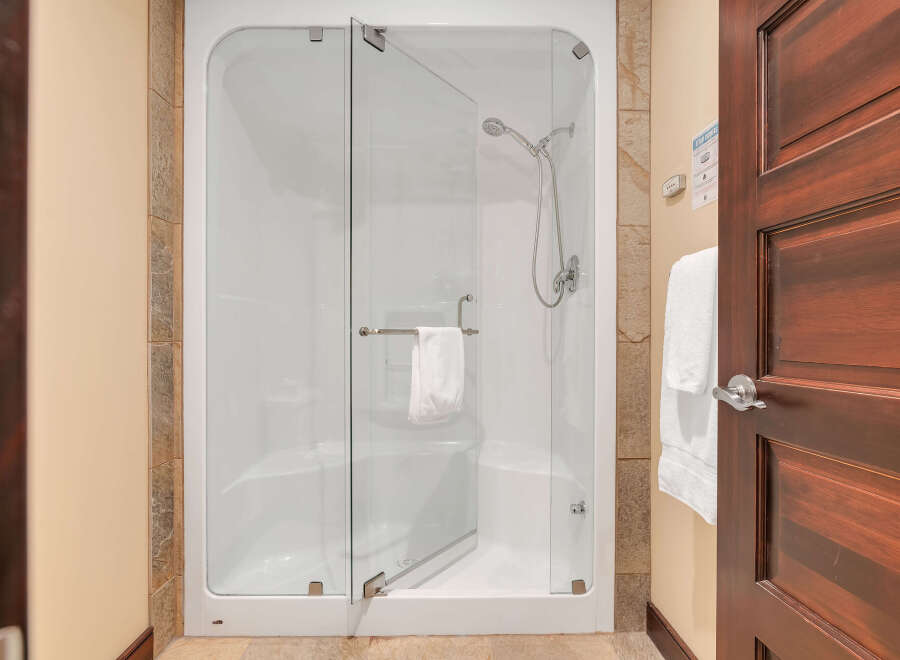 Step into luxury with this stunning bathroom featuring a modern glass shower.