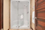 Step into luxury with this stunning bathroom featuring a modern glass shower.
