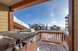 Enjoy the winter wonderland from this stunning property! This home features a cozy hot tub, perfect for relaxing after a day on the slopes.