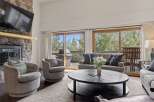 This stunning living room boasts a cozy fireplace and a large flat-screen TV, perfect for relaxing evenings.
