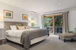Step into this serene bedroom, featuring a plush bed and a cozy seating area.