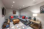 This cozy living space features a comfortable sectional sofa, perfect for relaxing and entertaining.