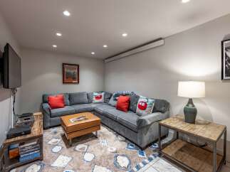 This cozy living space features a comfortable sectional sofa, perfect for relaxing and entertaining.