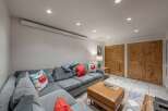 This cozy living room features a comfortable sectional sofa, perfect for relaxing after a long day.