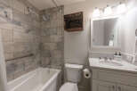 This stunning bathroom features a modern design with elegant tile work and a luxurious soaking tub.