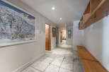 Step into this inviting entryway, featuring a stylish ski resort map and a convenient wooden bench.