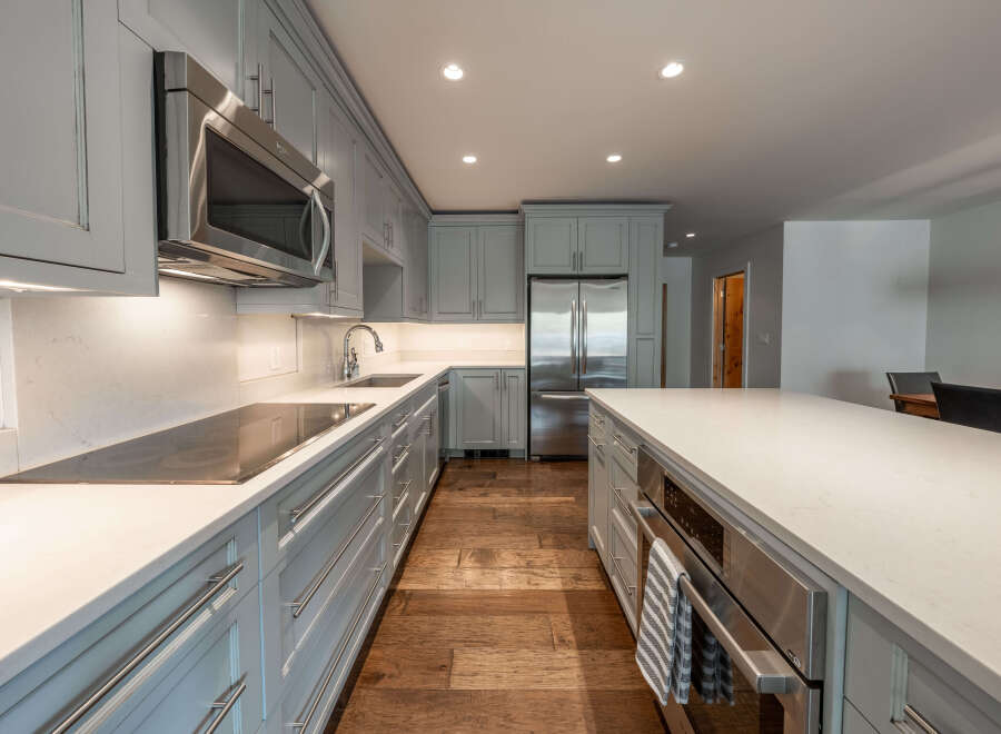 This stunning kitchen boasts a modern design with sleek cabinetry and high-end appliances.