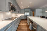 This stunning kitchen boasts a modern design with sleek cabinetry and high-end appliances.
