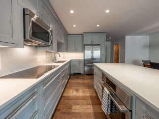 This stunning kitchen boasts a modern design with sleek cabinetry and high-end appliances.