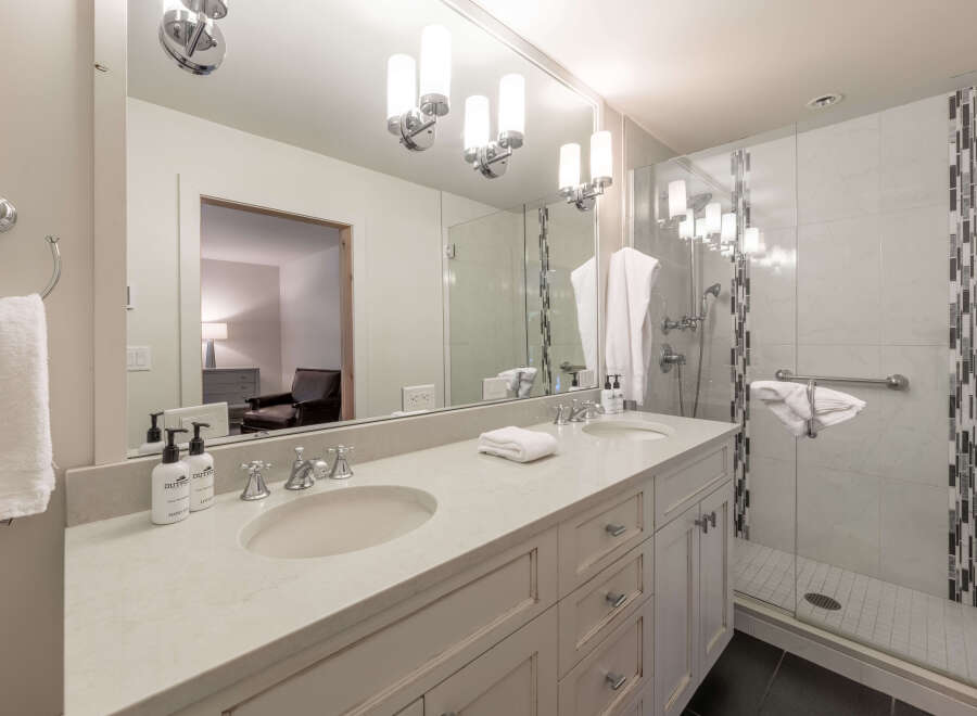 This luxurious bathroom features a double vanity with ample counter space and elegant fixtures.