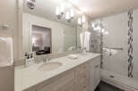 This luxurious bathroom features a double vanity with ample counter space and elegant fixtures.