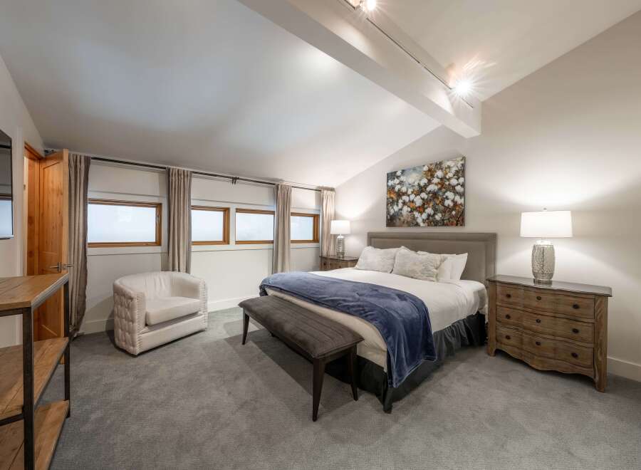 This stunning bedroom boasts a modern and inviting atmosphere, perfect for relaxation.