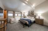 This stunning bedroom boasts a modern and inviting atmosphere, perfect for relaxation.