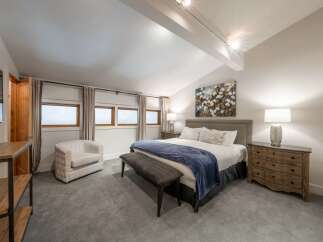 This stunning bedroom boasts a modern and inviting atmosphere, perfect for relaxation.
