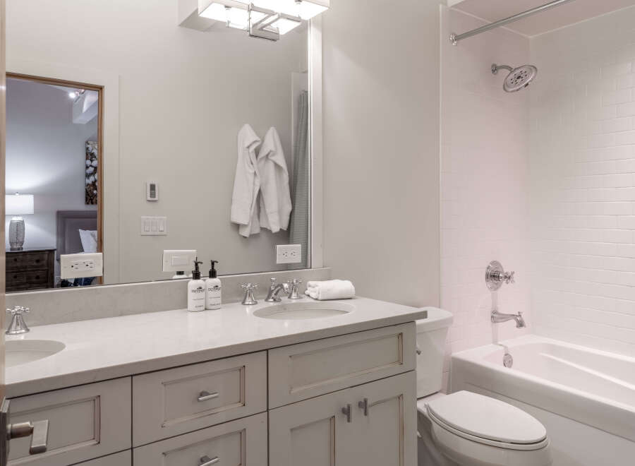 Step into a beautifully designed bathroom featuring a sleek vanity with ample storage and a pristine countertop.