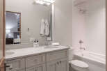 Step into a beautifully designed bathroom featuring a sleek vanity with ample storage and a pristine countertop.