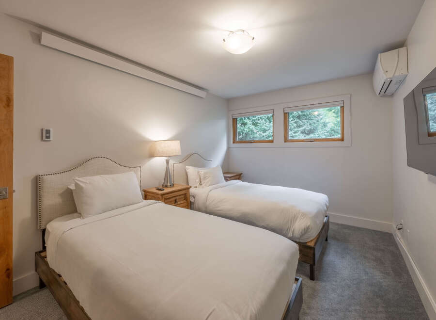This cozy bedroom features two twin beds, perfect for guests or family.