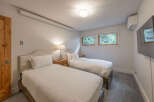 This cozy bedroom features two twin beds, perfect for guests or family.