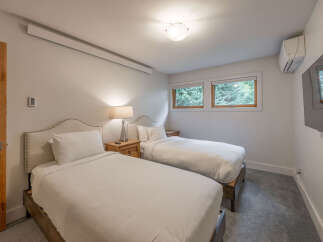 This cozy bedroom features two twin beds, perfect for guests or family.