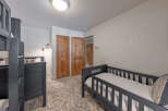 This cozy bedroom features a bunk bed and a toddler bed, perfect for a family or guests.