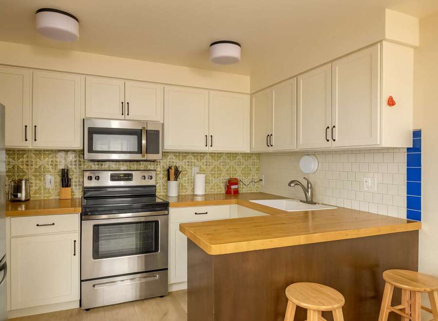 This charming kitchen boasts a modern design with stainless steel appliances and ample cabinet space.