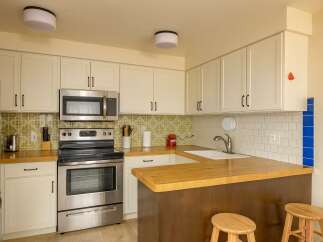 This charming kitchen boasts a modern design with stainless steel appliances and ample cabinet space.