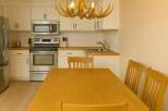 This charming kitchen features a warm and inviting dining area, perfect for family meals.