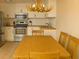 This charming kitchen features a warm and inviting dining area, perfect for family meals.