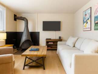 This cozy living room features a unique fireplace and a comfortable sofa, perfect for relaxing after a long day.