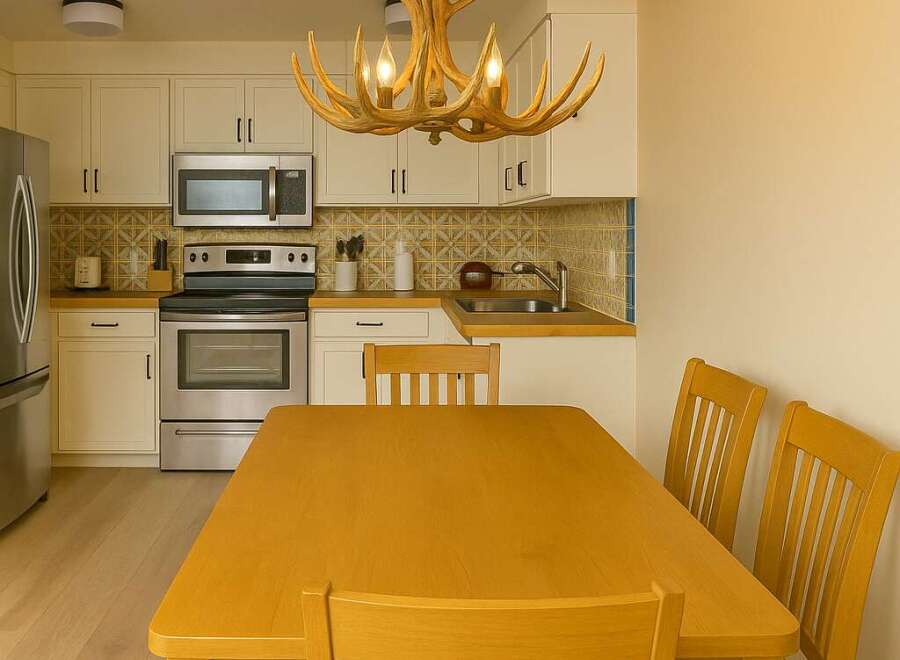 This charming kitchen features a unique antler chandelier, adding a touch of rustic elegance to the space.