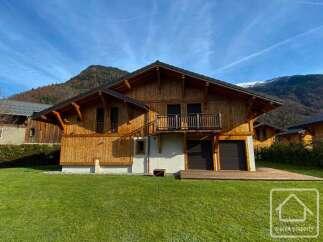 Discover the charm of this stunning wooden chalet nestled in a picturesque mountain setting.