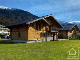 Discover the charm of this stunning wooden chalet nestled in a picturesque mountain setting.