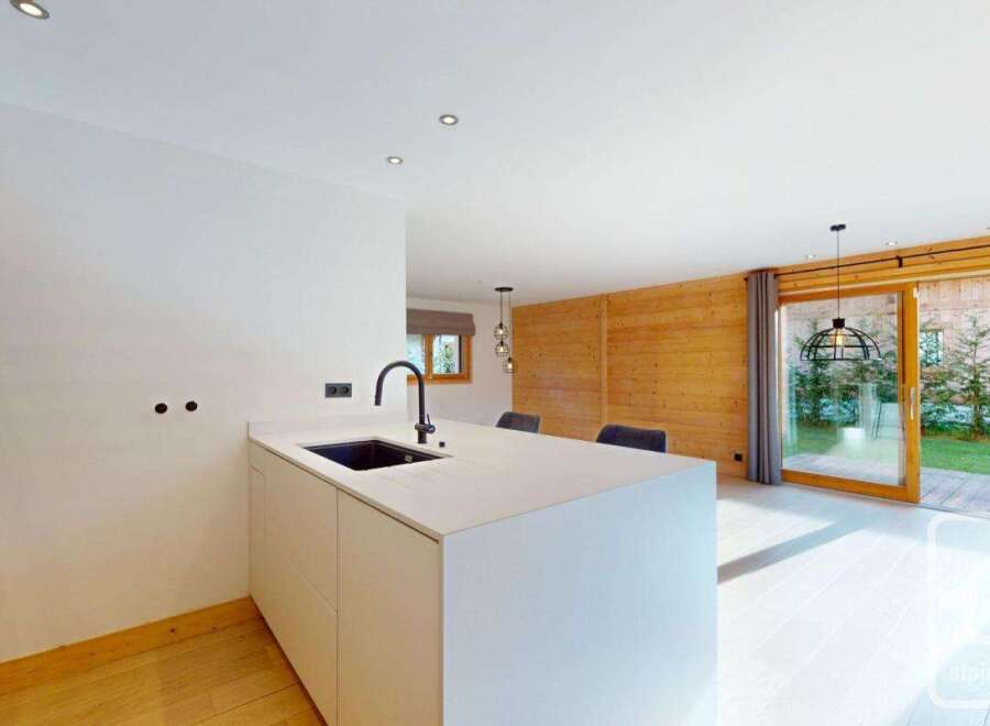 Discover modern living in this stunning property, featuring a sleek kitchen island with a built-in sink and contemporary design.