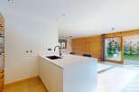 Discover modern living in this stunning property, featuring a sleek kitchen island with a built-in sink and contemporary design.