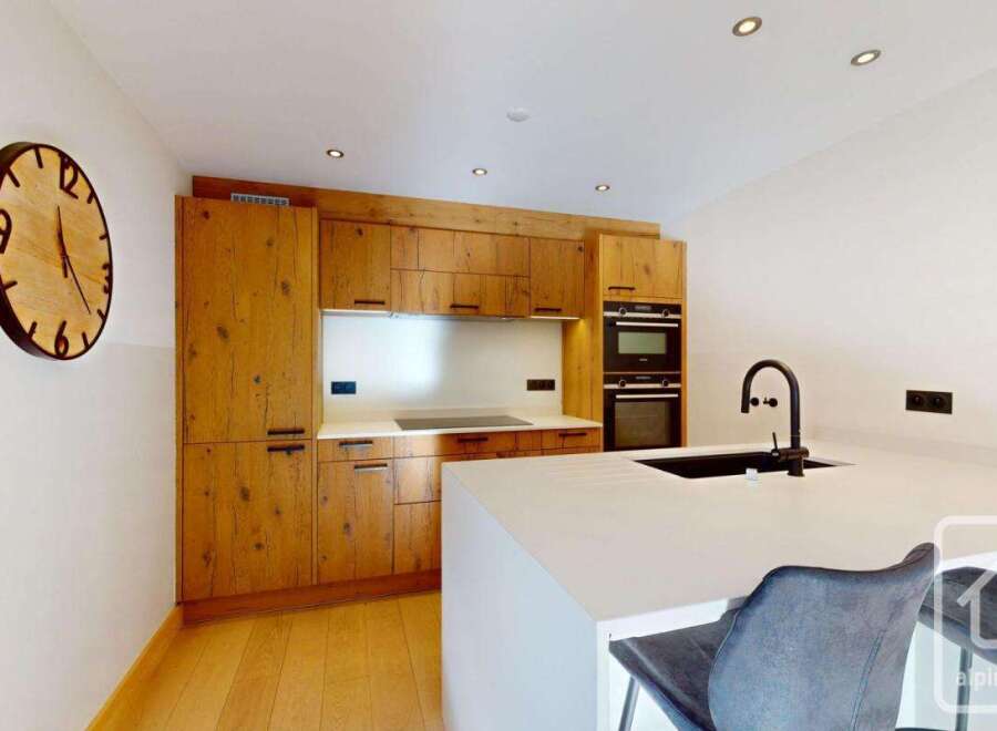This stunning kitchen boasts a modern design with high-end appliances and custom cabinetry.