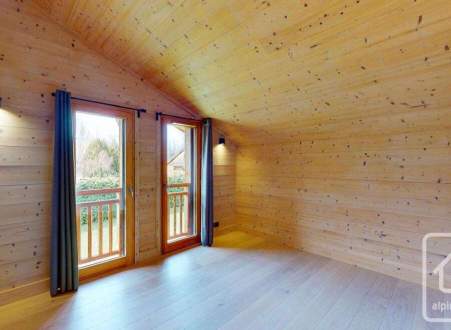 This stunning property boasts a warm and inviting interior with beautiful wooden walls and ceilings.