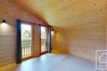 This stunning property boasts a warm and inviting interior with beautiful wooden walls and ceilings.