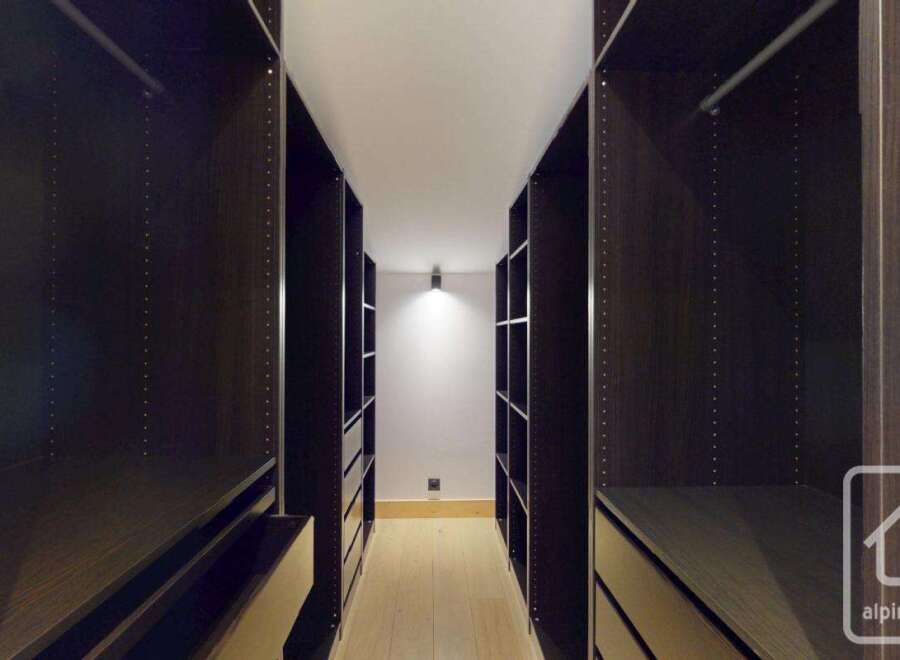Step into luxury with this stunning walk-in closet, designed for both style and functionality.