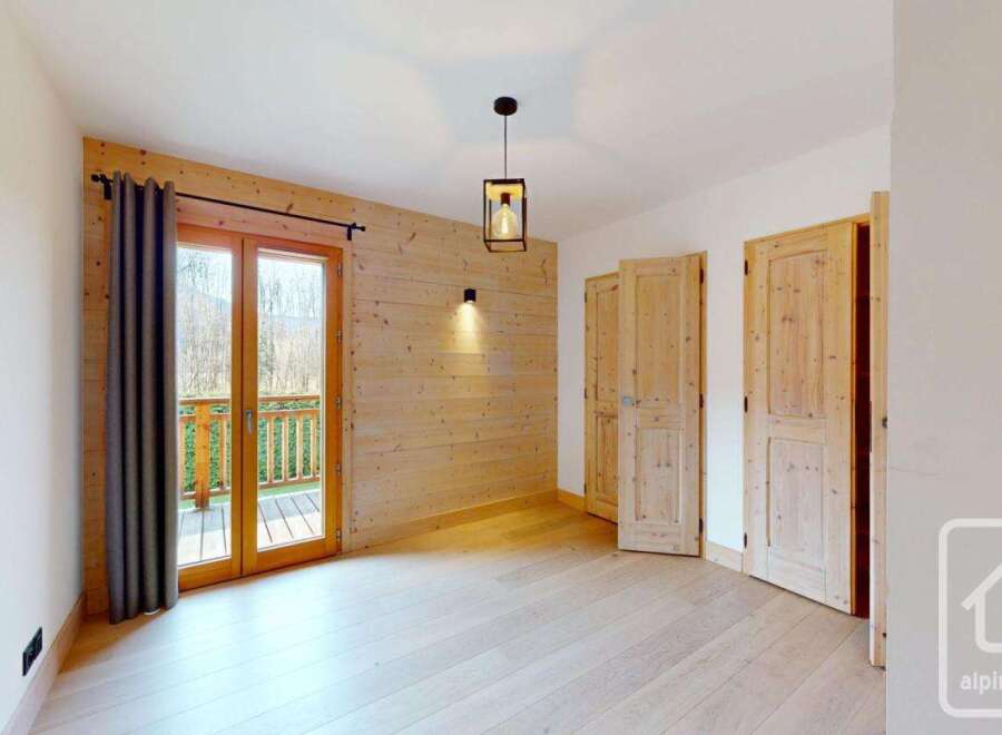 This stunning property boasts a warm and inviting interior with beautiful wooden accents throughout.