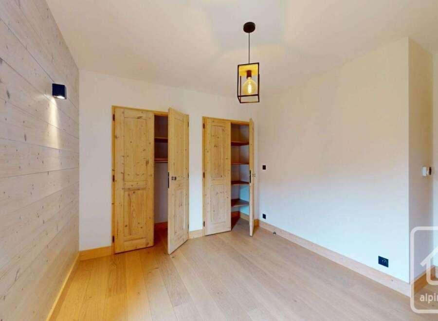 Discover the charm of this inviting room, featuring a stunning wooden wall that adds warmth and character.
