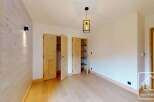 Discover the charm of this inviting room, featuring a stunning wooden wall that adds warmth and character.