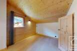 Discover the charm of this cozy room, featuring beautiful wooden walls and ceilings that create a warm and inviting atmosphere.
