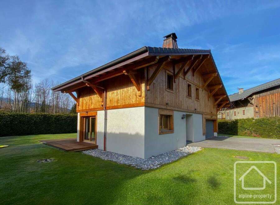 This stunning property showcases a beautiful wooden chalet design, blending seamlessly with its natural surroundings.