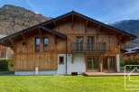Discover the charm of this stunning wooden chalet nestled in a picturesque mountain setting.