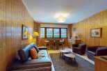This charming property features a cozy living room with a comfortable leather sofa and two armchairs, perfect for relaxing.