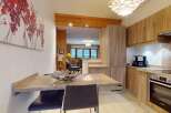 This stunning property boasts a modern kitchen with sleek cabinetry and high-end appliances, perfect for culinary enthusiasts.