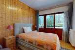 This cozy bedroom features a warm wooden paneling, creating a rustic and inviting atmosphere.