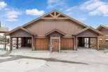 This stunning property boasts a beautiful exterior with a combination of wood and stone accents.